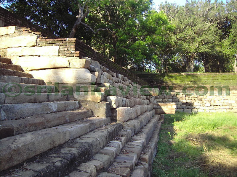 Stone steps leading into the pond and dried bottom section of the pond during a drought period.