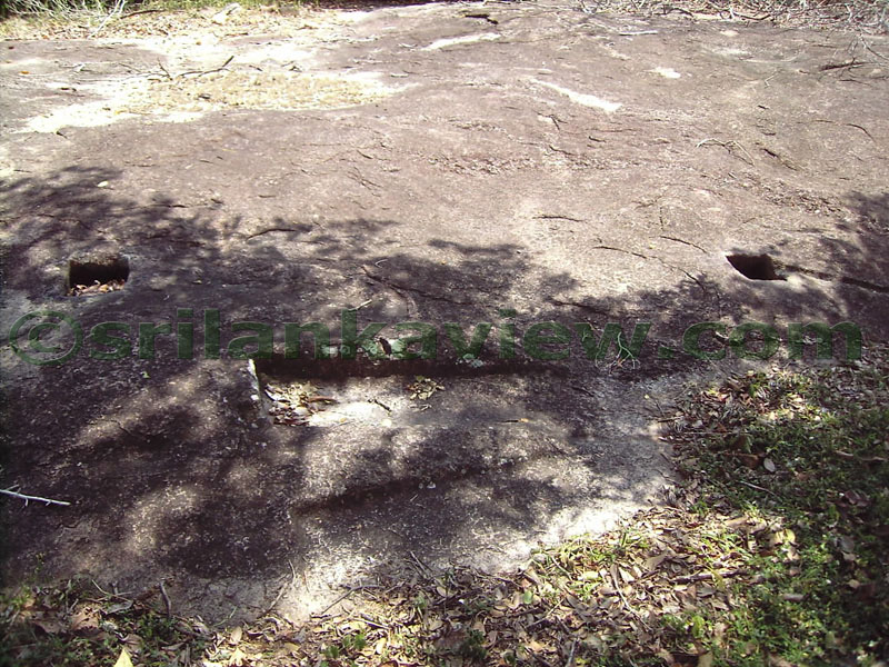 Steps and anchor holes found in tth rock which were used for an earlier building.