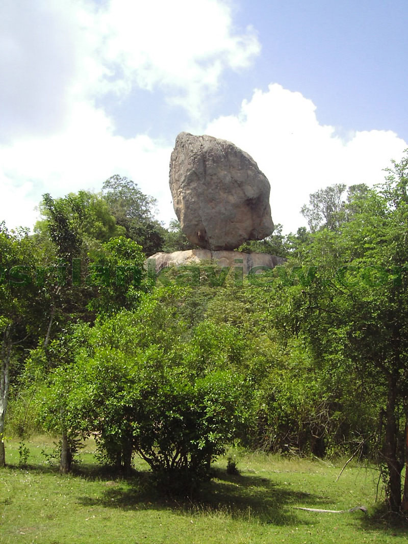 Closely seen here is the balancing rock sitting on a larger rock.Hattikuchchi Viharaya