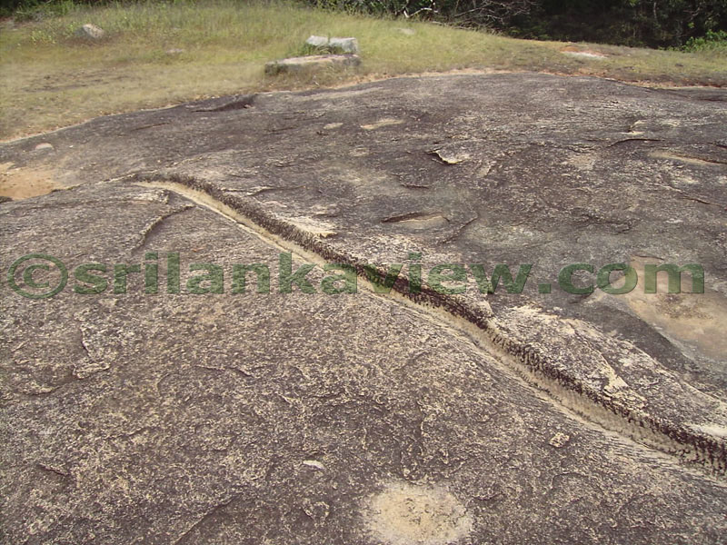 A drain cut on the rock surface.