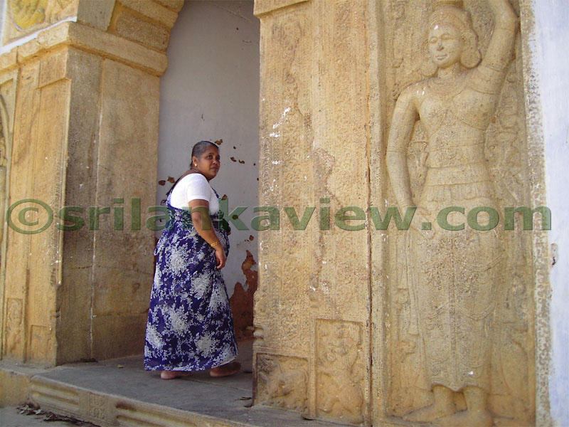 Entrance through stone arch ,big enough for an elephant to walk through,is decorated with carved figures.Natha Temple, Kandy.