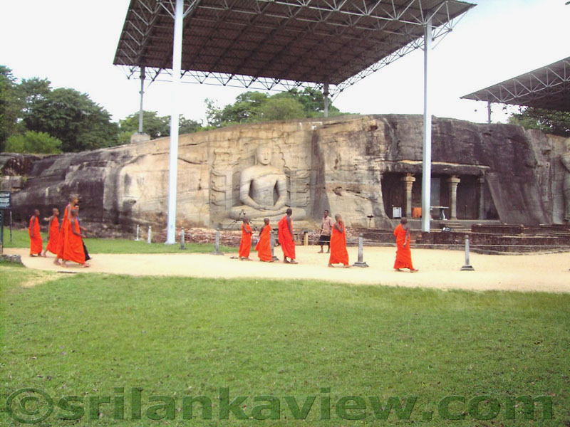 The Seated Buddha Statue and Buddhist monks visiting Gal Viharaya