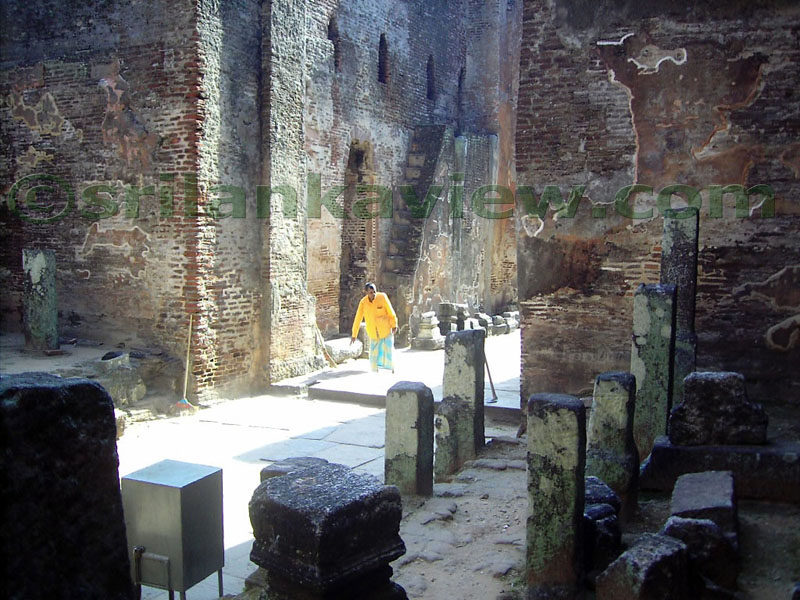 Flight of steps leading to the upper floor of the image house at earlier times can be seen behind the person in a yellow shirt.