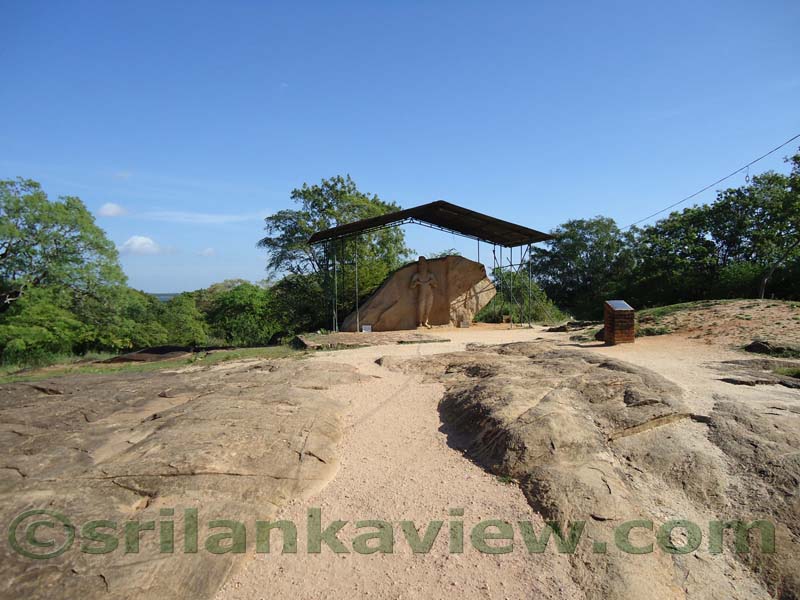 The Statue carved out of the rock boulder can be seen.
