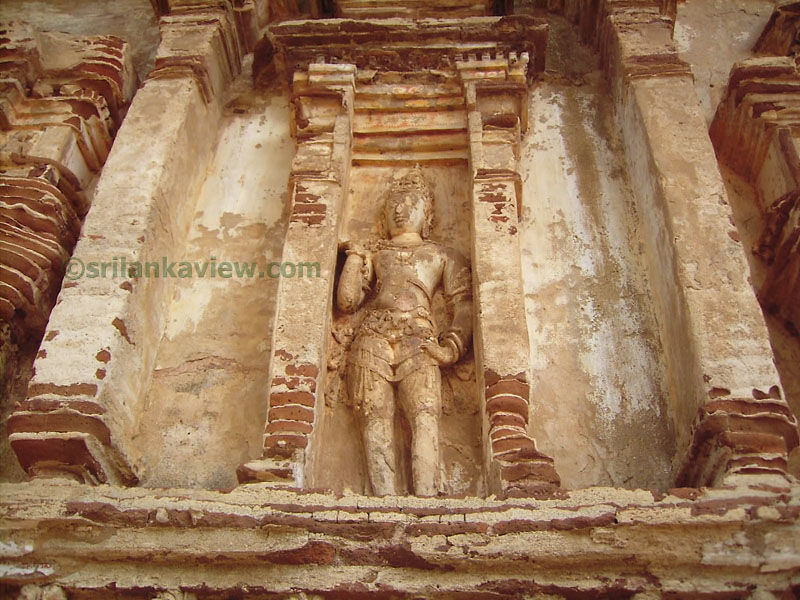 A finely sculptured Guardian figure inside a niche.