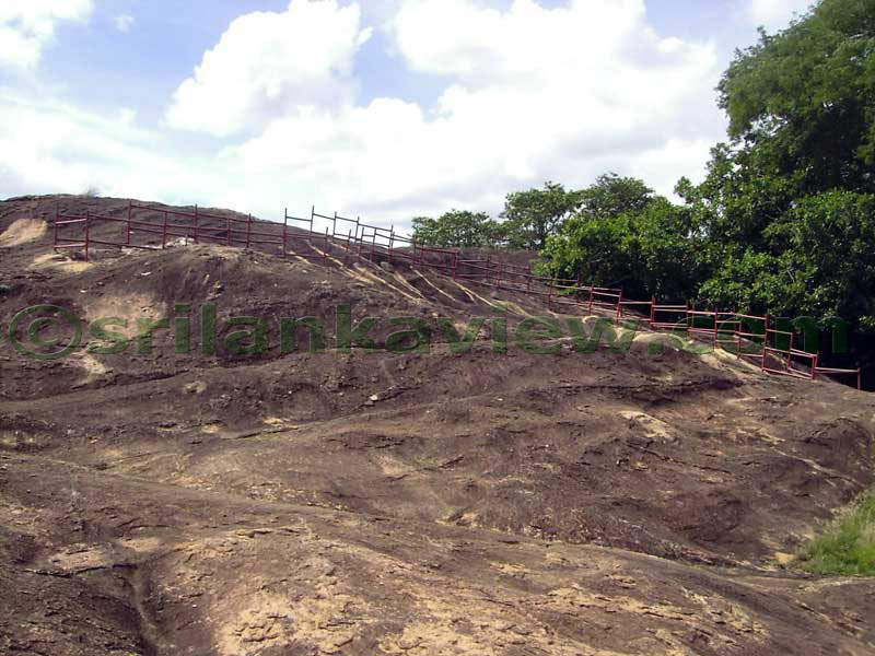 On the rock where the inscriptions are found, is covered by this metal fence.